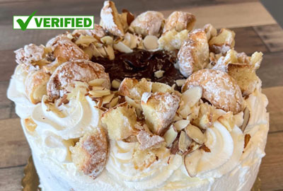 Elegant white frosted cake with whipped cream and almonds from Linda's Dolci in Northeast Albuquerque.
